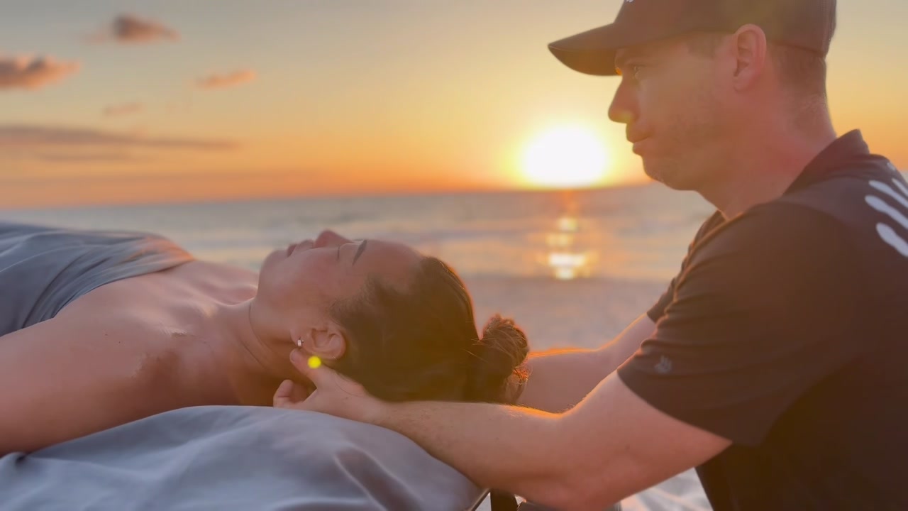 Carlos Blain performing a neck and shoulder treatment on a client